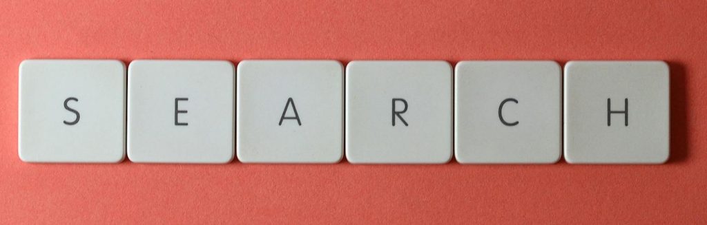 White keyboard keys spelling 'search' on a bold red surface, conceptual design with copyspace.