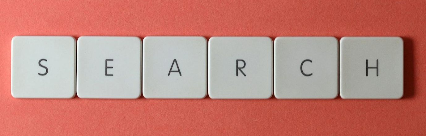 White keyboard keys spelling 'search' on a bold red surface, conceptual design with copyspace.